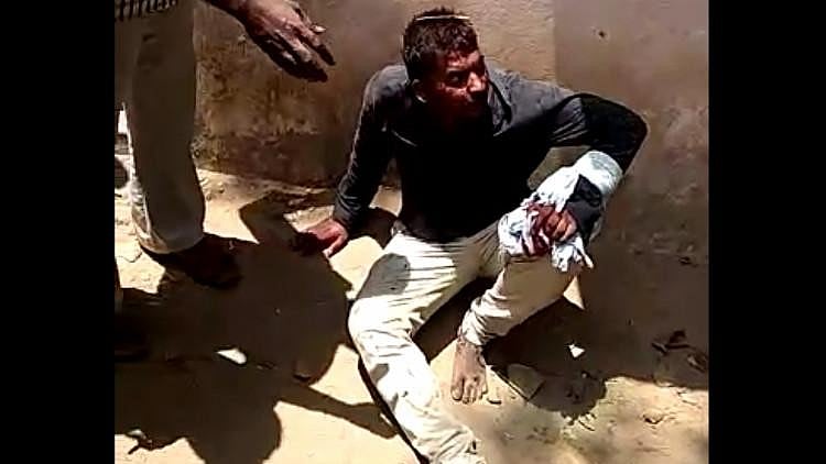 The accused, Nandakumar after being held by the public.