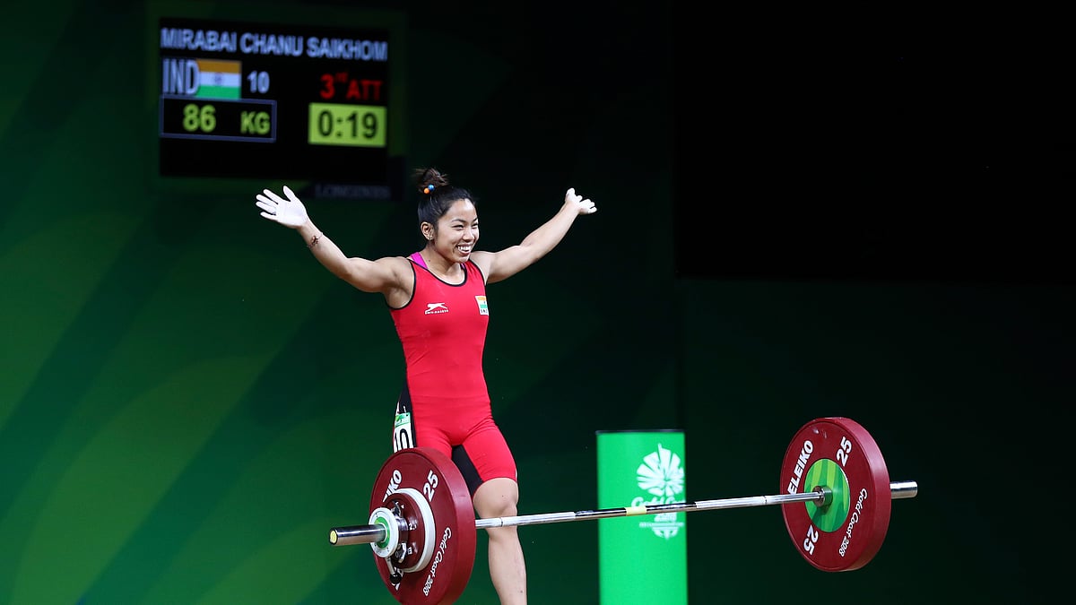 Mirabai Chanu celebrates after setting a new record.