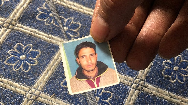 A relative showing a picture of Manzoor Bhat.
