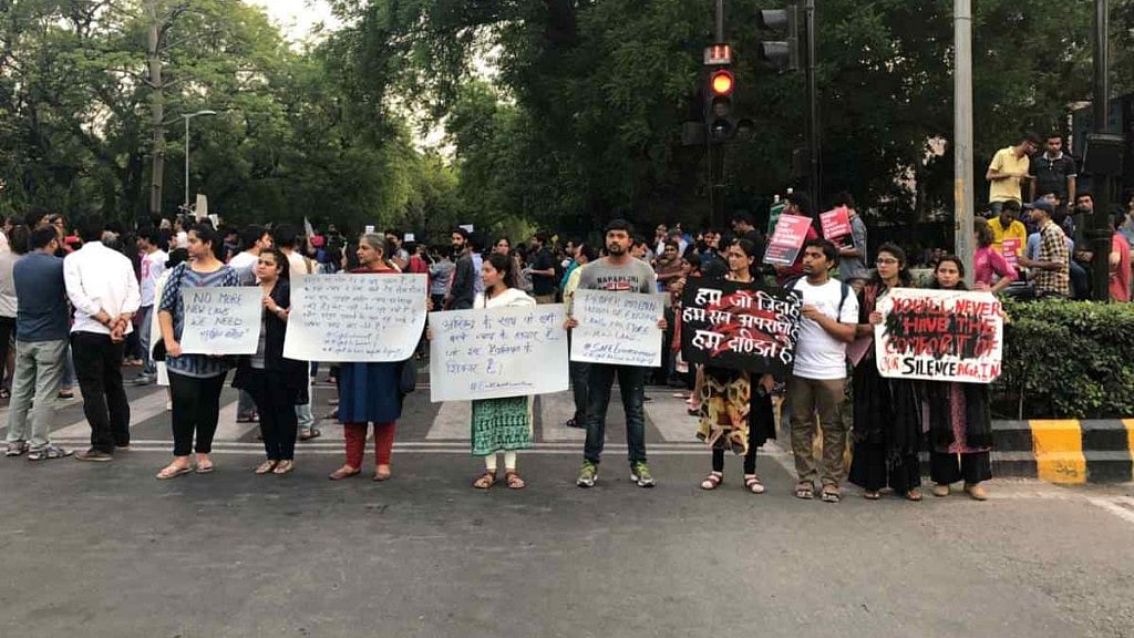 Protesters hold placards in solidarity in Delhi on Sunday, 15 April. 