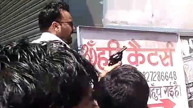 Raja Chauhan (top) with his gun during the protests.