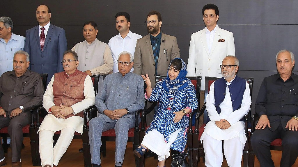 Jammu & Kashmir Governor NN Vohra and Chief Minister Mehbooba Mufti with Deputy Chief Minister Kavinder Gupta pose for a group photograph with the newly appointed minister after a reshuffle in Jammu on Monday.