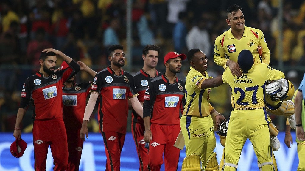 Chennai Super Kings’ Harbhajan Singh, right, lifts captain Mahendra Singh Dhoni to celebrate their win in the match against Royal Challengers Bangalore.