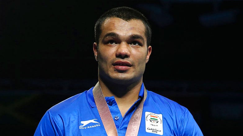 Vikas Krishan stands on the podium.