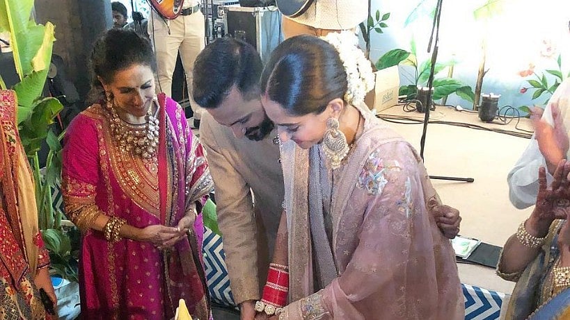 Sonam and Anand cut their wedding cake. 