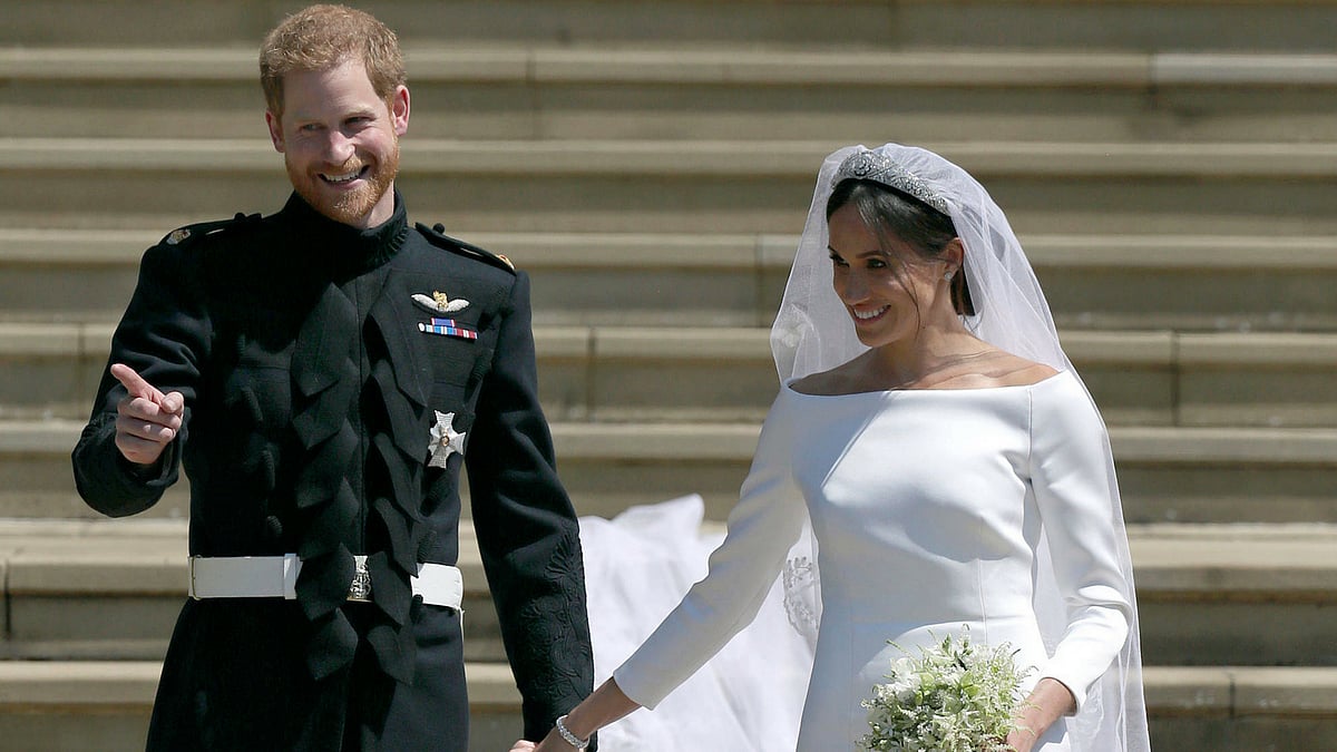 Prince Harry and Meghan Markle greet fans. 