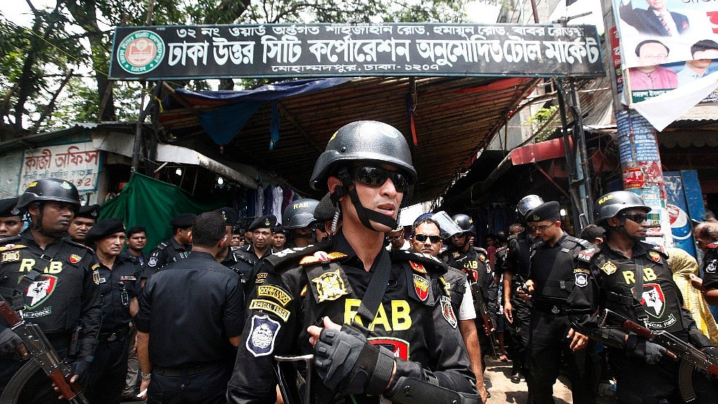 Bangladesh’s Rapid Action Battalion (RAB) soldiers stand guard during a raid on suspected drug dealers at Mohammadpur Geneva Camp in Dhaka, Bangladesh, Saturday, 26 May, 2018. 