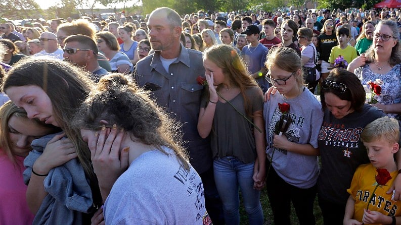 Mourners during a prayer vigil following the school shooting at Santa Fe High School, Texas