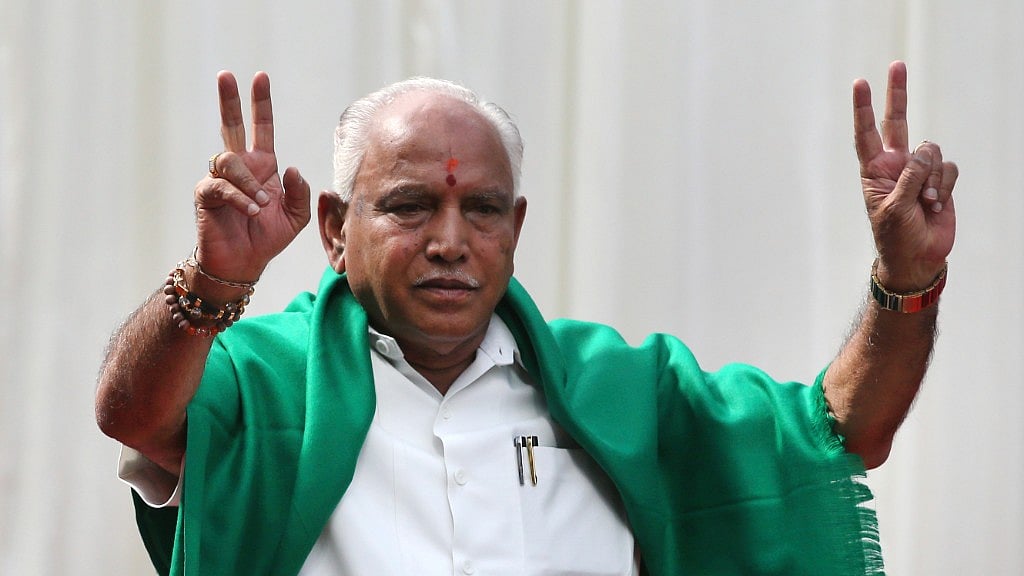 BJP’s BS Yeddyurappa flashes victory sign after he was sworn in as the chief minister of Karnataka in Bengaluru.