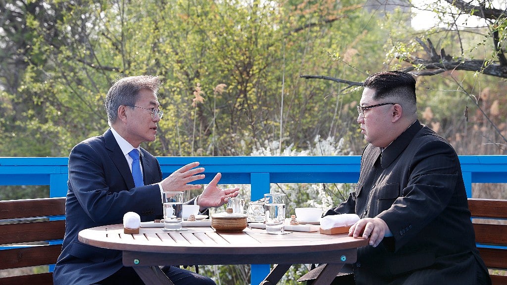 In this 27 April, 2018 photo, North Korean leader Kim Jong Un, right, and South Korean President Moon Jae-in, left, talk at a footbridge at the border village of Panmunjom in the Demilitarized Zone, South Korea.
