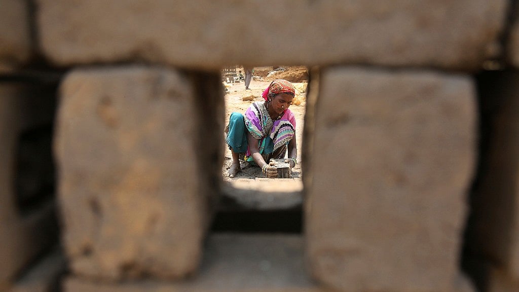 An Indian labourer works at a brick factory on the outskirts of Jammu, India, Tuesday, 1 May 2018.