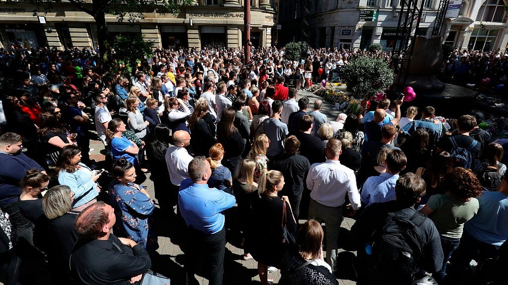 Members of the public observe a minutes silence as they gather in St Ann’s Square to mark one year since the terror attack on Manchester Arena.
