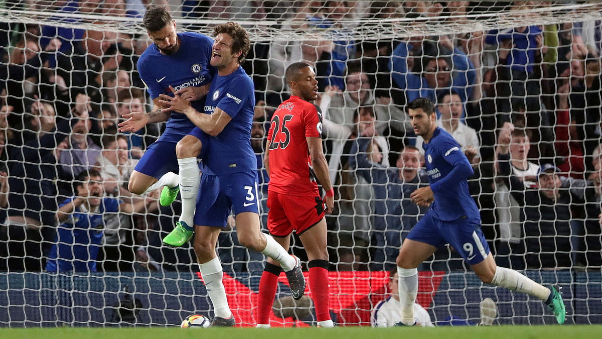 Chelsea’s Marcos Alonso, second left, celebrates scoring his side’s first goal of the game against Huddersfield Town with teammate Olivier Giroud during the English Premier League soccer match at Stamford Bridge, London, Wednesday May 9, 2018.&nbsp;