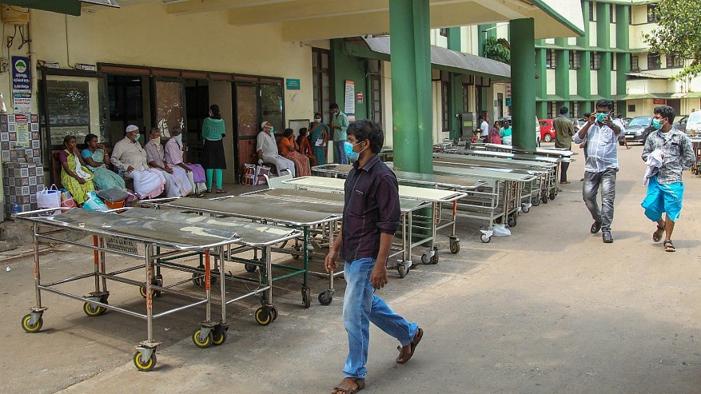 Patients wear safety masks as a precautionary measure after the Nipah virus outbreak, outside Medical college, in Kozhikode.