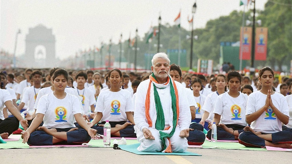 Prime Minister Narendra Modi performs yoga along with other participants during a mass yoga session on the International Day of Yoga 2015 at Rajpath in New Delhi. 