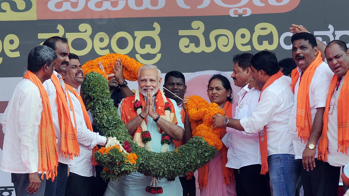 File photo of Prime Minister Narendra Modi being garlanded by BJP workers during Karnataka election rally.