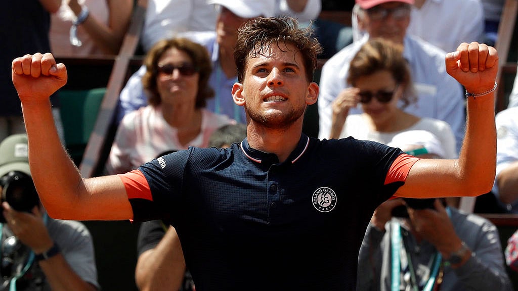 Austria’s Dominic Thiem raises his arms in victory as he defeats Italy’s Marco Cecchinato in the semi-final of the French Open. 