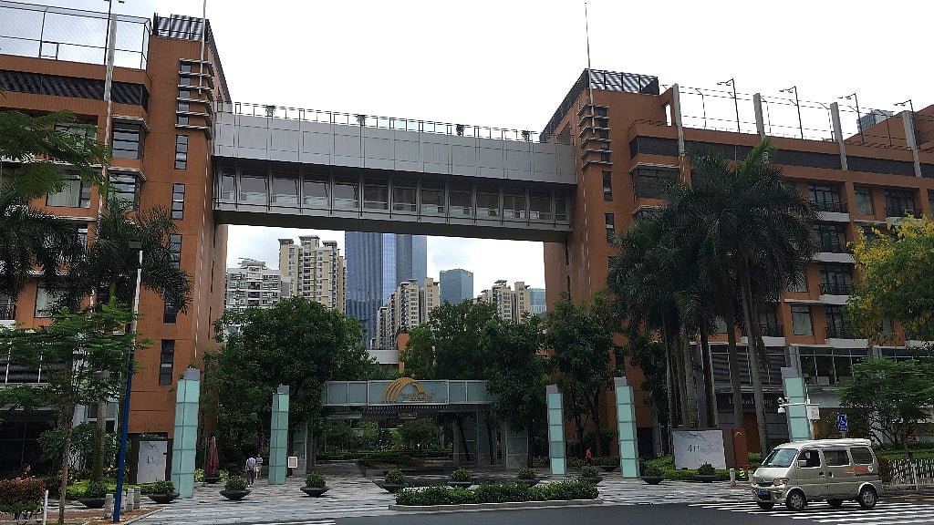 A van passes high-rise apartment buildings in The Canton Place where US government workers experienced unexplained health issues.