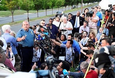 ANNAPOLIS (U.S.), June 29, 2018 (Xinhua) -- A police officer speaks to the media near the scene of a mass shooting in Annapolis, the capital city of eastern U.S. state Maryland, on June 28, 2018. Five people were killed on Thursday afternoon with several "gravely injured" in a mass shooting at local daily newspaper Capital Gazette in Annapolis, the capital city of eastern U.S. state Maryland, police said. (Xinhua/Yang Chenglin/IANS)