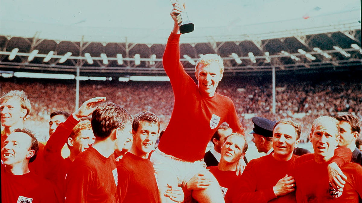 In this July 30 1966 file photo, England’s soccer captain Bobby Moore, carried shoulder high by his teammates, holds aloft the Jules Rimet Trophy. England defeated Germany 4-2 in the final of the 1966 World Cup at London’s Wembley Stadium. 