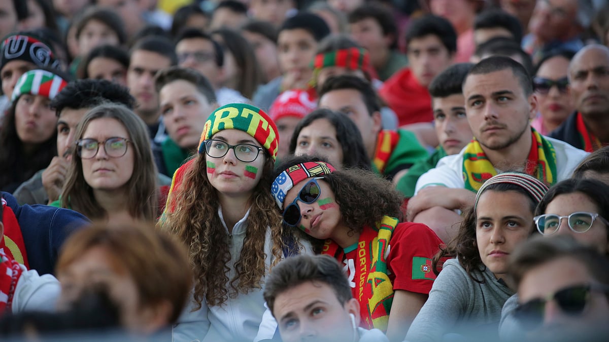 Portugal fans watch the 2018 soccer World Cup group B match between Portugal and Spain being shown on a video screen in Lisbon’s Comercio square, Friday, June 15 2018. 