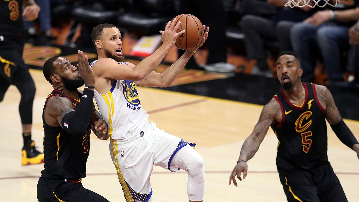 Golden State Warriors’ Stephen Curry goes to the basket against Cleveland Cavaliers’ LeBron James, left, during the second half of Game 3 of basketball’s NBA Finals.