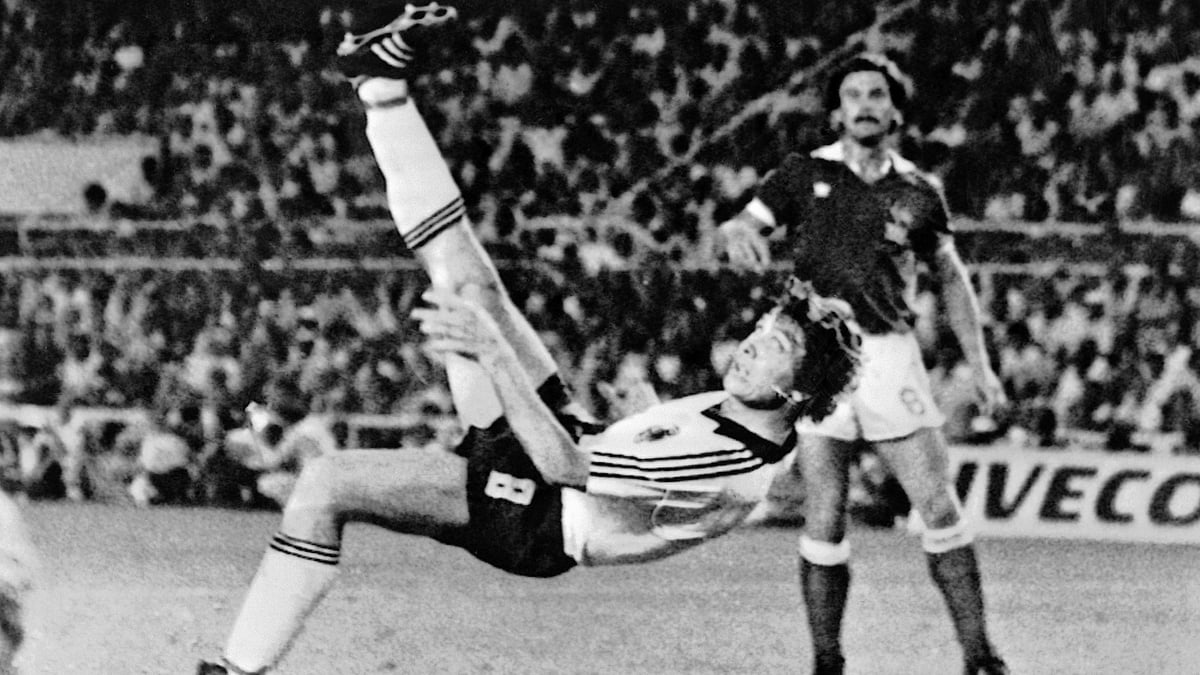 In this 8 July 1982 file photo, West Germany’s Klaus Fischer scores the third goal and equalises in the World Cup semifinal football match against France, in Seville, Spain. West Germany defeated France in a penalty shoot out after a 3-3 draw.