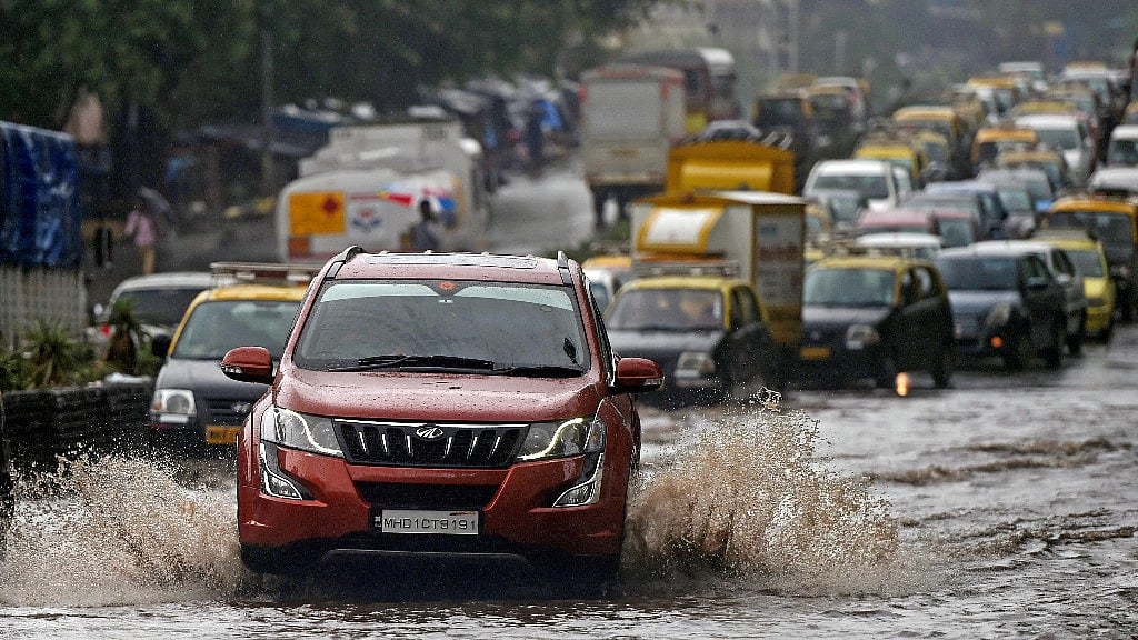 Vehicles wade through water-logged tracks during heavy rains in Mumbai.
