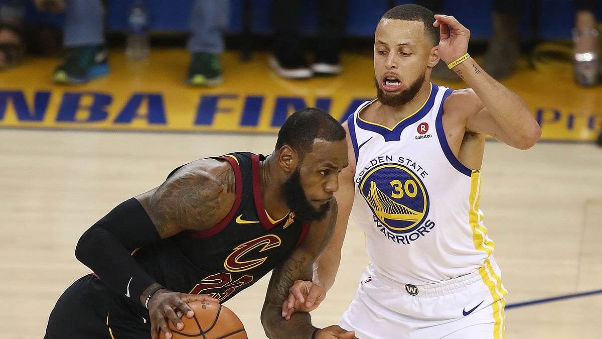 Cleveland Cavaliers forward LeBron James, left, drives against Golden State Warriors guard Stephen Curry during the first half of Game 1 of basketball’s NBA Finals.