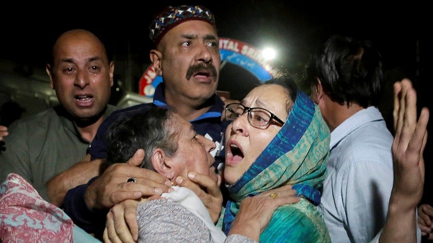 Relatives and friends of the Editor of “Rising Kashmir” Shujaat Bukhari, who was shot dead Thursday evening, cry inside a police control room in Srinagar.