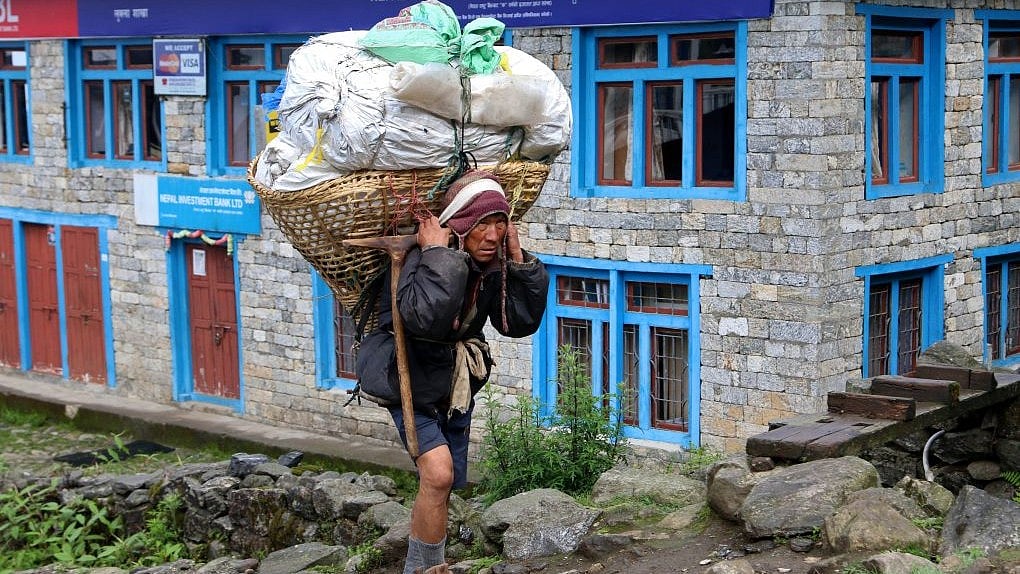 Porters carrying stuff to Lukla airport from Namche bazaar, a town on the way to Everest base camp.