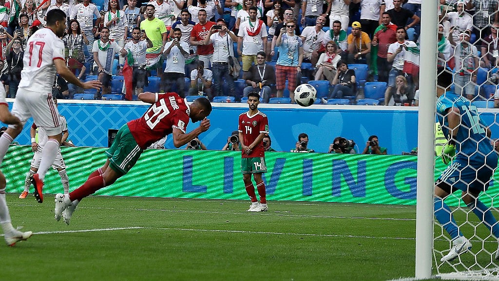 Morocco’s Aziz Bouhaddouz scores the own goal.
