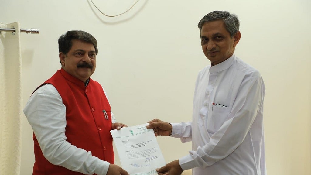 (Right) Kunvarji Bavaliya hands his resignation as Congress MLA of Jasdan Constituency to Gujarat Assembly Speaker Rajendra Trivedi (left).