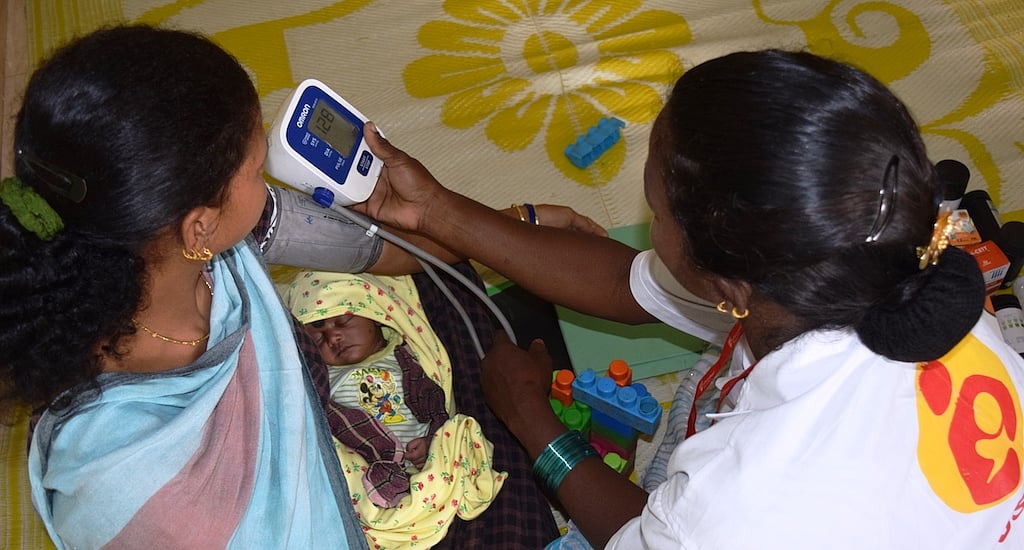 A lactating mother is being checked for blood pressure at the daycare center in Godiguda village in Araku Valley 
