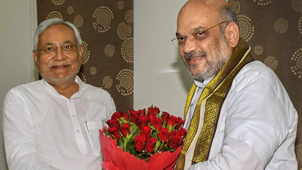 Bihar CM Nitish Kumar and BJP President Amit Shah exchange greetings at the state guest house, in Patna on Thursday, July 12.