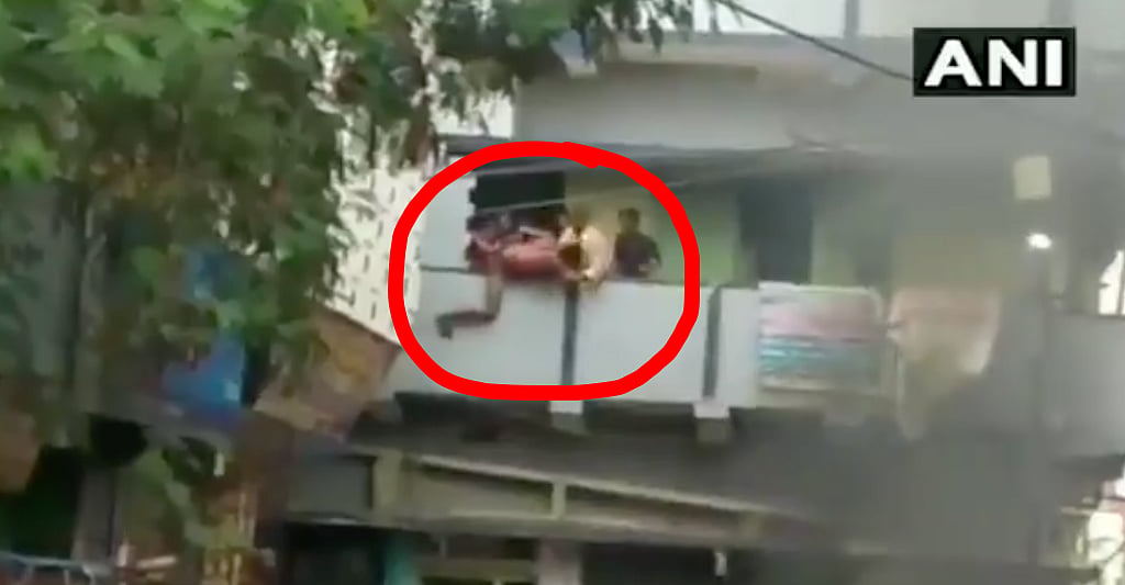 Man being thrown off a balcony in Nalanda’s Bihar Sharif by group of people. 