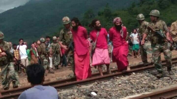 Three ‘sadhus’ being rescued by security personnel in Assam. 