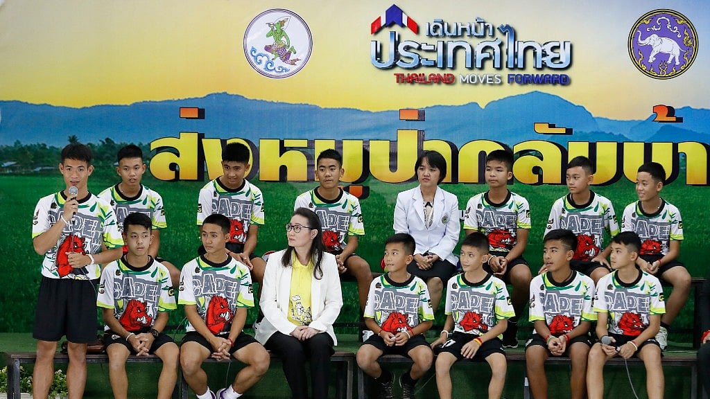 Coach” Ake” Ekkapol Janthawong, left, speaks on behalf of the 12 boys and himself and their cave rescue during a press conference discussing their ordeal in Chiang Rai, northern Thailand, Wednesday, July 18, 2018. 