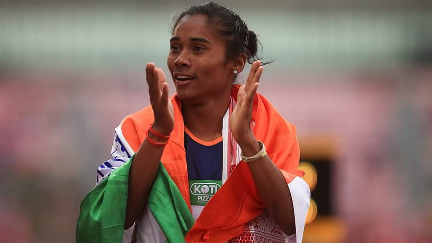 Hima Das celebrates with the Indian flag after winning her 400m Gold at the U-20 World Championships in Tampere, Finland