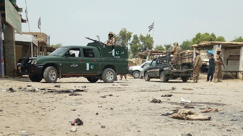 Pakistan army troops guard the area of suicide attack at an election rally in Bannu, Pakistan, Friday, 13 July.