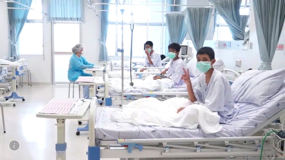 The 12 boys rescued from deep within a flooded cave in northern Thailand made two-finger victory signs from their hospital beds.