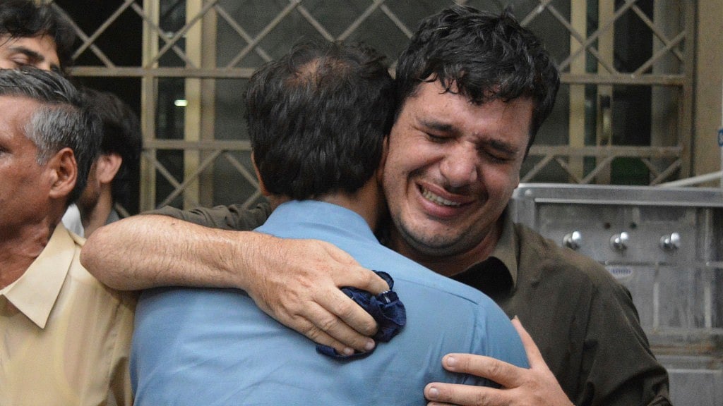 Pakistani relative mourn the death of their family member at a hospital in Peshawar, Pakistan on Tuesday, 10 July.