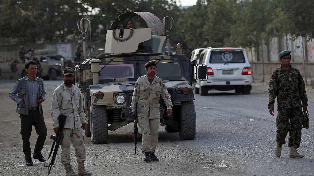 Security personnel patrol near the site of a deadly attack outside the Rural Rehabilitation and Development Ministry in Kabul, Afghanistan.