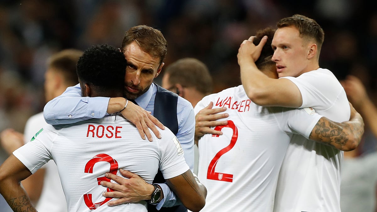 England head coach Gareth Southgate, 2nd left, comforts England’s Danny Rose, left, after loosing the semifinal match between Croatia and England at the 2018 soccer World Cup in the Luzhniki Stadium in Moscow, Russia, Wednesday, July 11, 2018. 