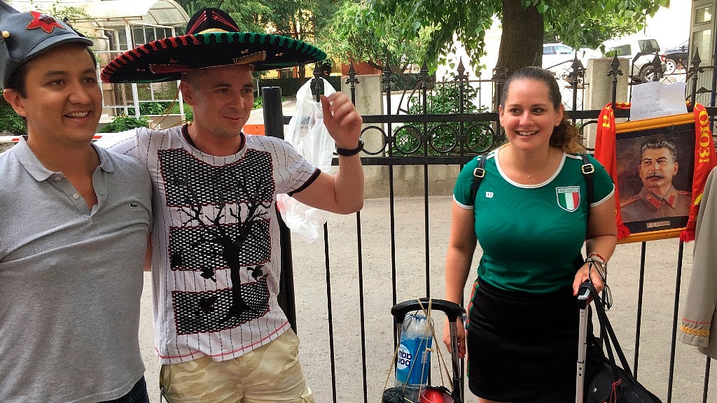 A local resident (centre) who rents replicas of Joseph Stalin uniforms outside of the Stalin bunker in Samara, Russia, is flanked by Mexican fans, Edgard Ramírez and his wife, Edly Mortera.