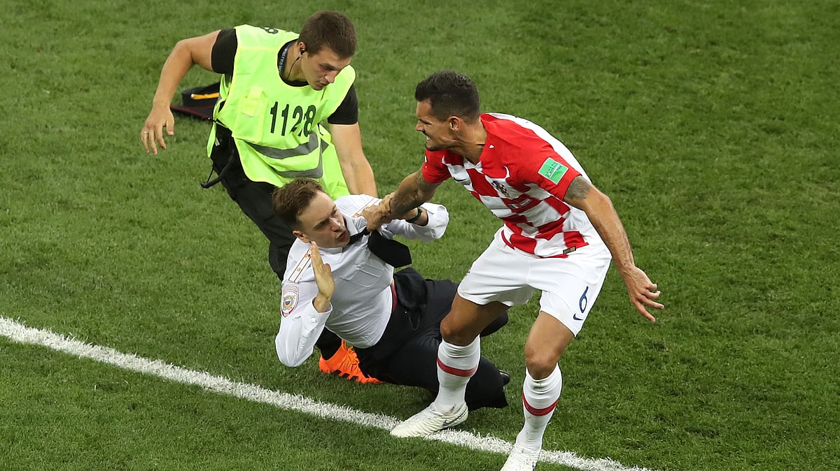 Croatia’s Dejan Lovren and a steward grab a man who invaded the pitch during the final match between France and Croatia at the 2018 soccer World Cup in the Luzhniki Stadium in Moscow, Russia, Sunday, July 15, 2018. 