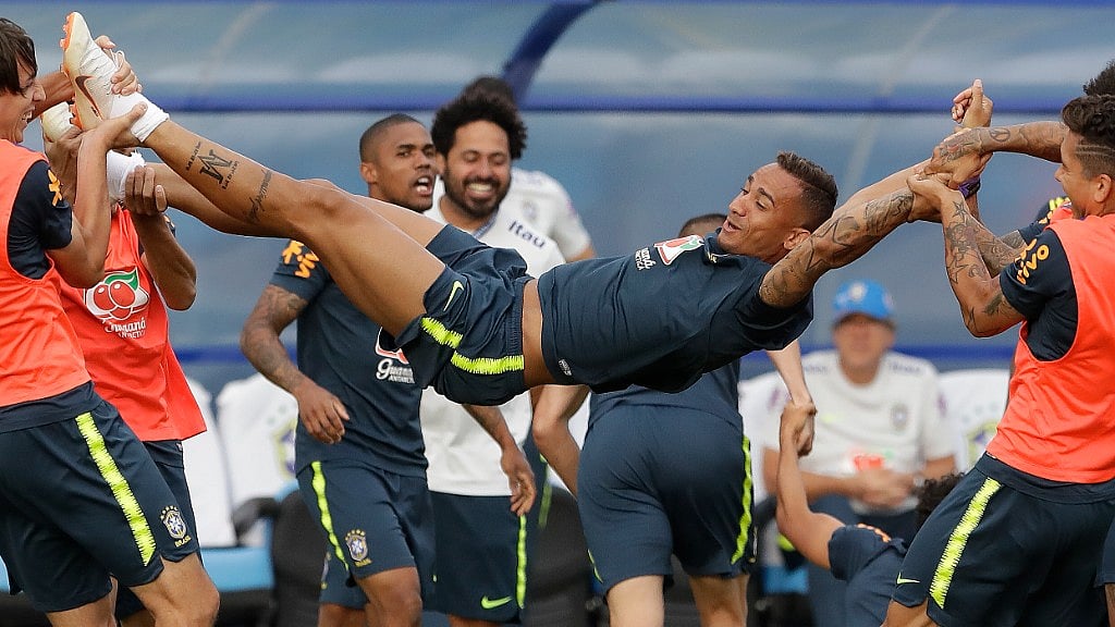 Danilo getting stretched by his teammates at a Brazil training session