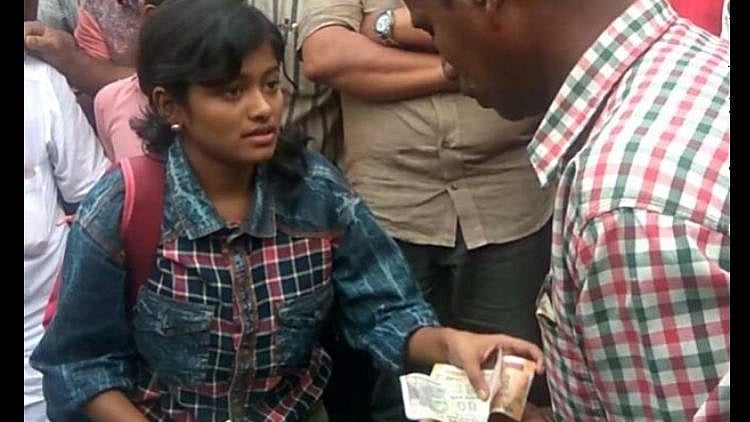 Hanan Hamid sells fish in the local market to fund her college education. 