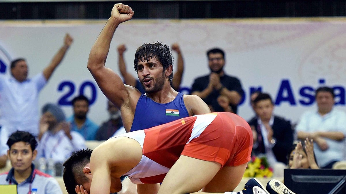 Asian Games 2018: India’s wrestler Bajrang Punia with Uzbekistan’s Khasanov Sirojiddin in the men’s freestyle wrestling (65kg) qualification round at the Asian Games 2018, in Jakarta on Sunday, August 19, 2018. 