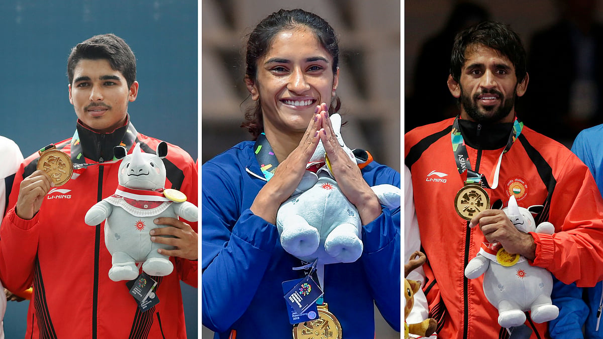 Gold medallists, Saurabh Chaudhary (L) Vinesh Phogat (C) and Bajrang Punia (R) at the award ceremony.